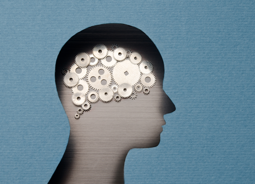 Human head with brain shaped with gears